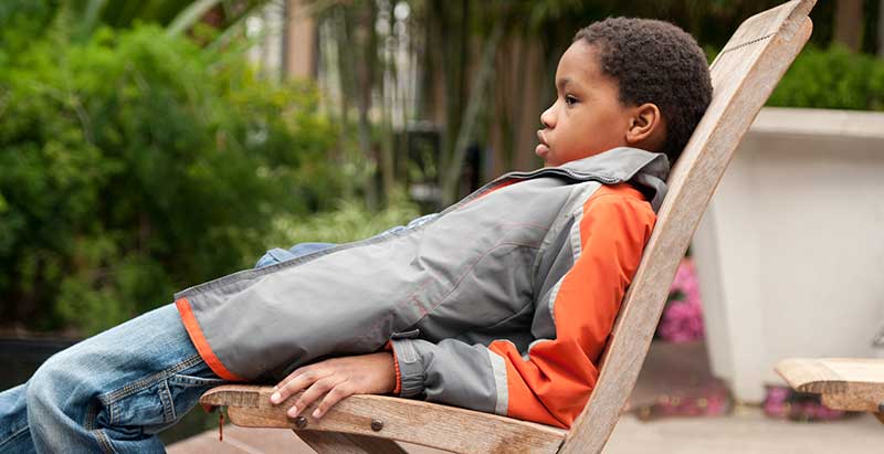 Kid sitting with poor slouching posture