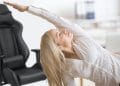 Woman with healthy back stretching in front of gaming chair