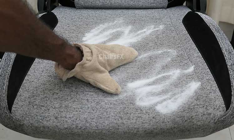 Rubbing baking soda into fabric gaming chair