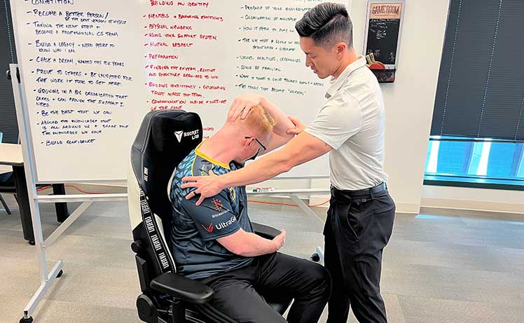 Evil Geniuses esports player doing neck exercises with Dr. Jordan Tsai