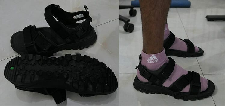 Man using Timberland's Garrison Trail Webbing Sandals at a standing desk