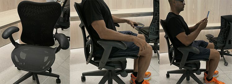Man sitting in a Herman Miller Mirra 2 side profile