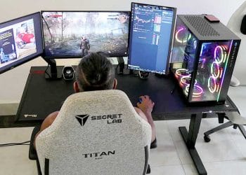Rear overhead view of a man playing video games using a Secretlab Magnus Pro desk