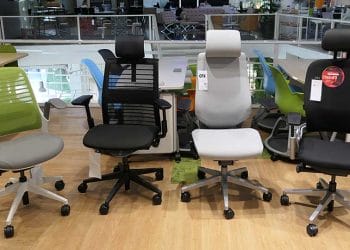 Four Steelcase office chairs posed together in a showroom