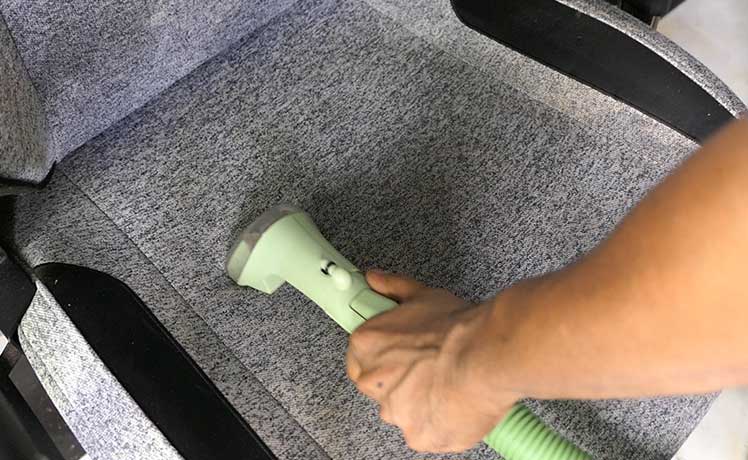Using a wet suction vacuum on a fabric gaming chair