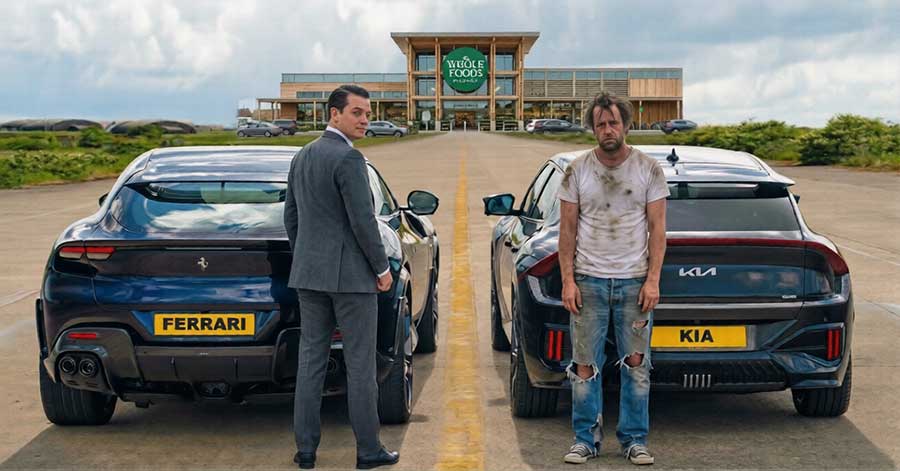 Rich man in front of a Ferrari standing next to a poor man in front of a Kia