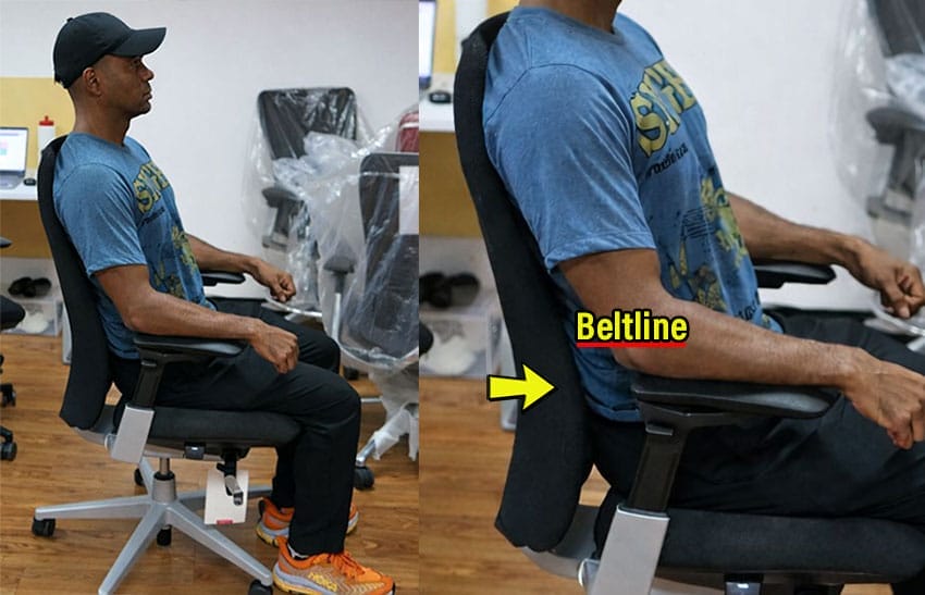 Side-by-side images showing a person seated in a Haworth Fern chair, with a close-up highlighting the built-in lumbar curve positioned below the wearer’s beltline, illustrating how the lumbar support sits too low for proper alignment.